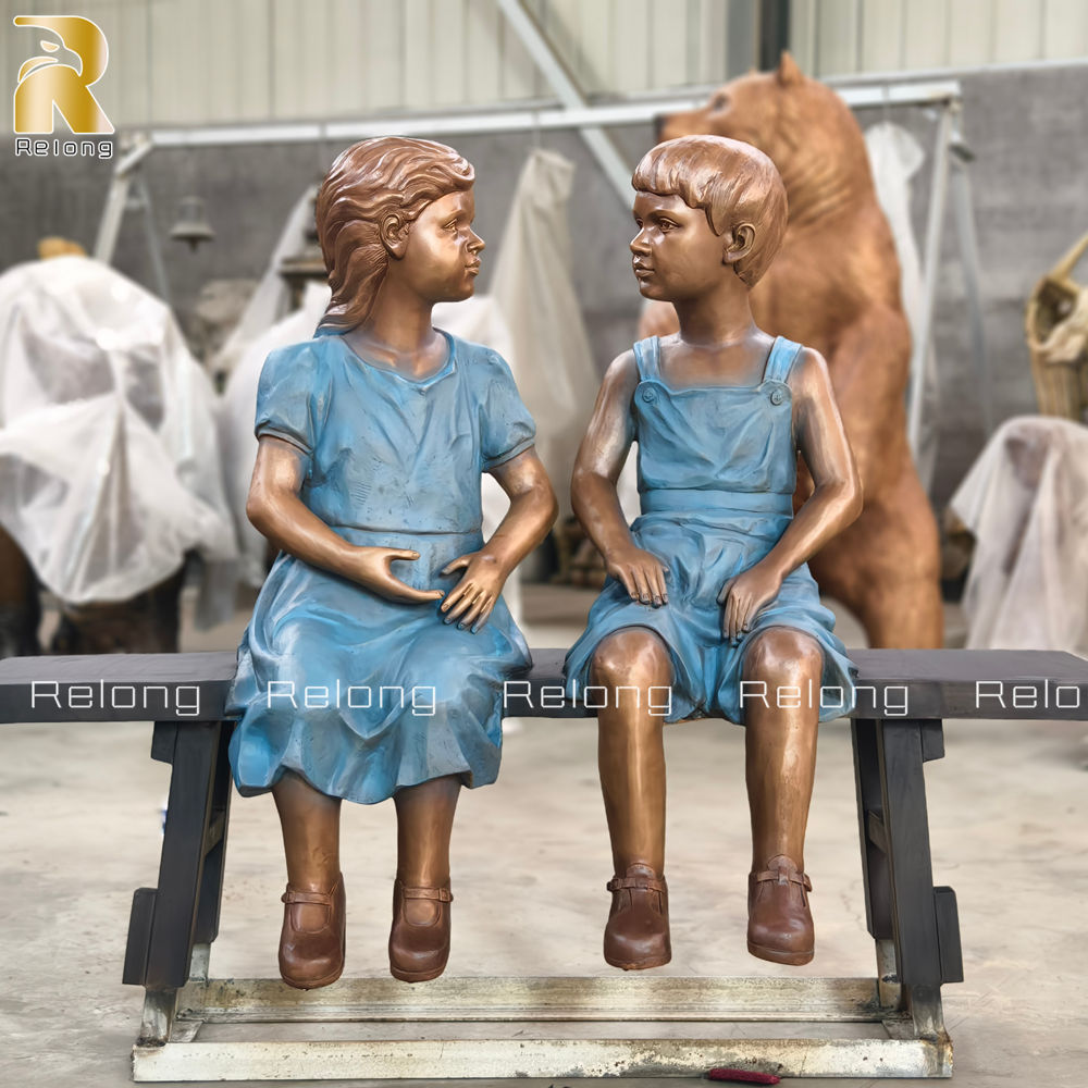 cast bronze boy and girl sculpture
