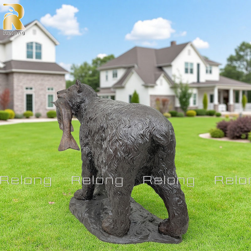 bear catches fish in mouth statue