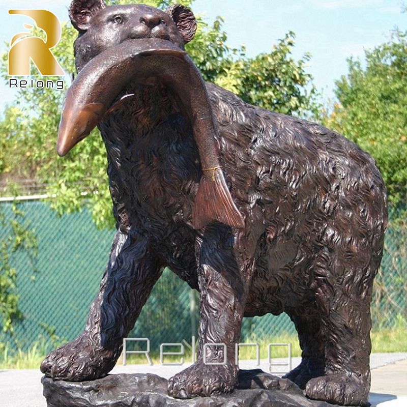 bear with fish in mouth statue