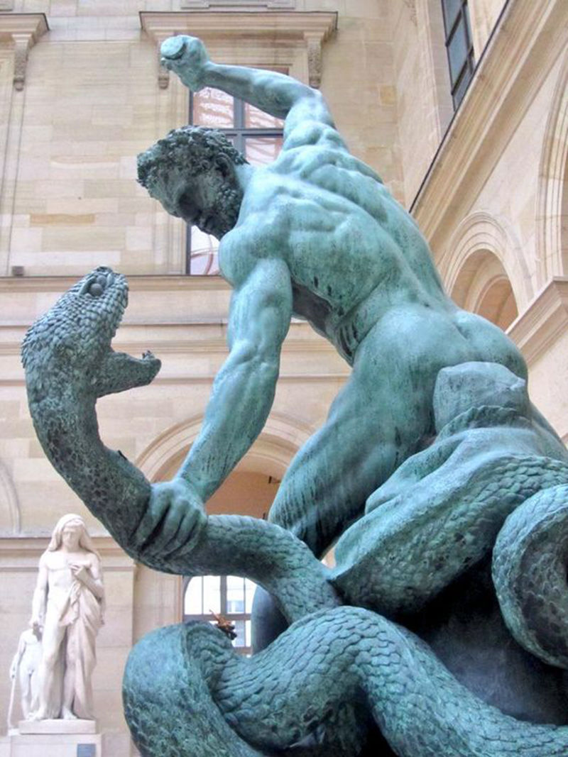 bronze statue of man fighting snake