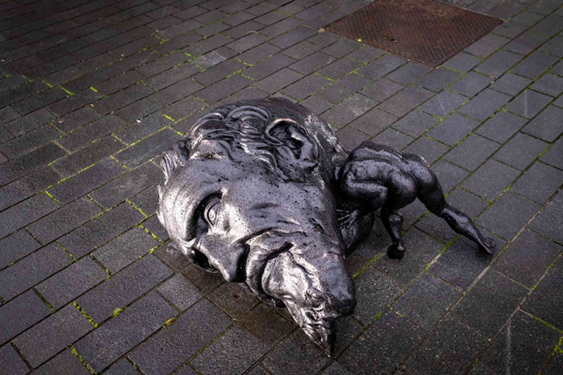 outdoor bronze big head little body sculpture