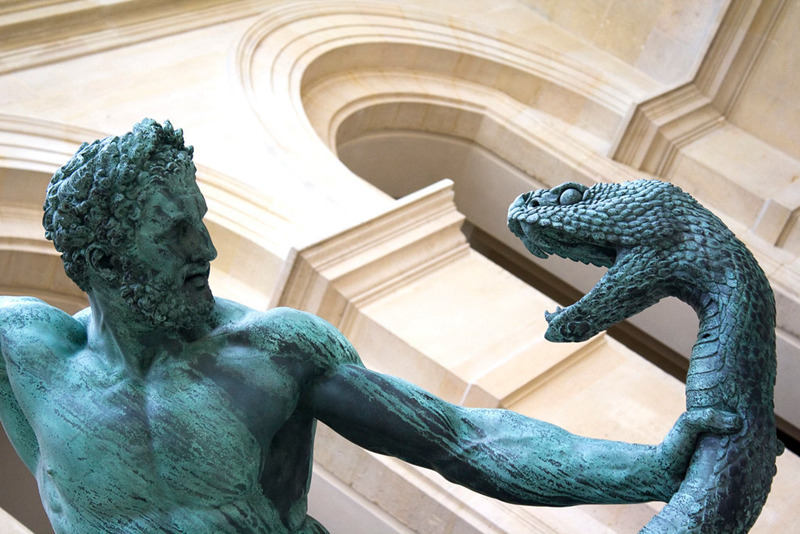 statue of man fighting snake