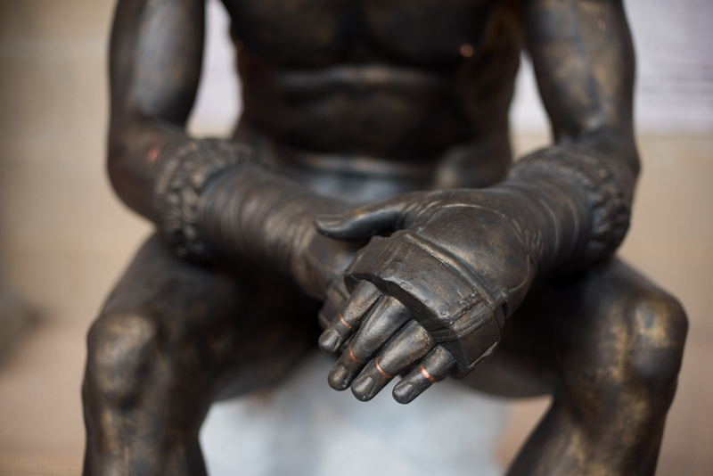 cast bronze seated boxer statue