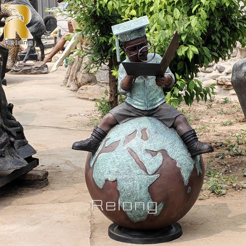 bronze boy reading statue