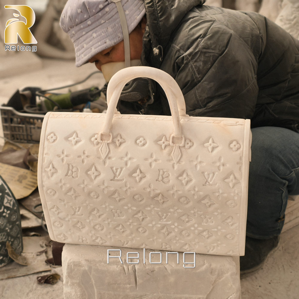 hand carving process of marble bag sculpture