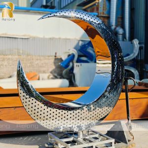 high polished metal moon sculpture
