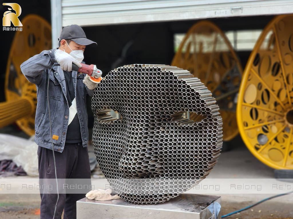 stainless steel face sculpture