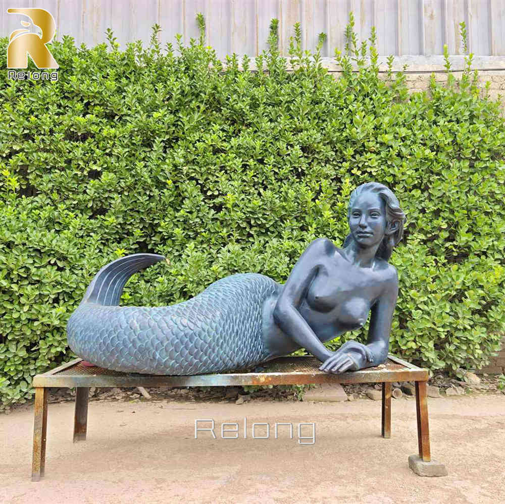bronze mermaid lying down statue