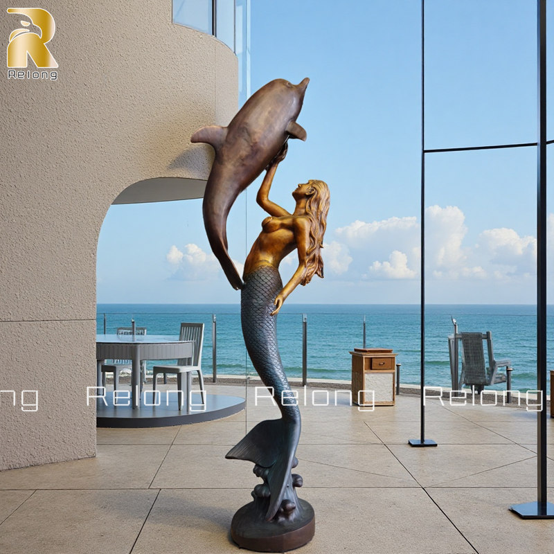 large mermaid with dolphin tatue