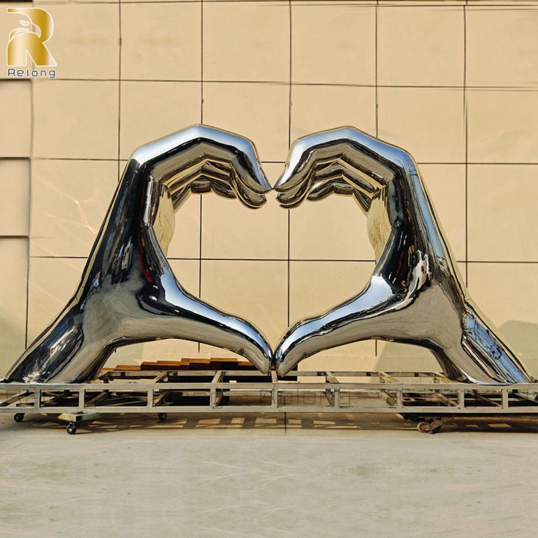 large stainless steel hand sculpture