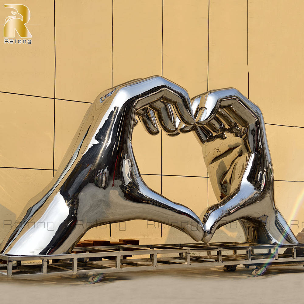 metal hand heart sculpture