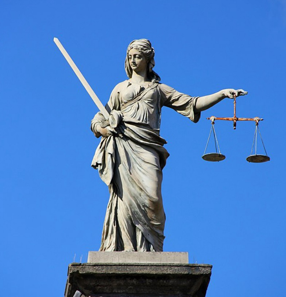 Statue Of Justitia Holding The Scales Of Justice
