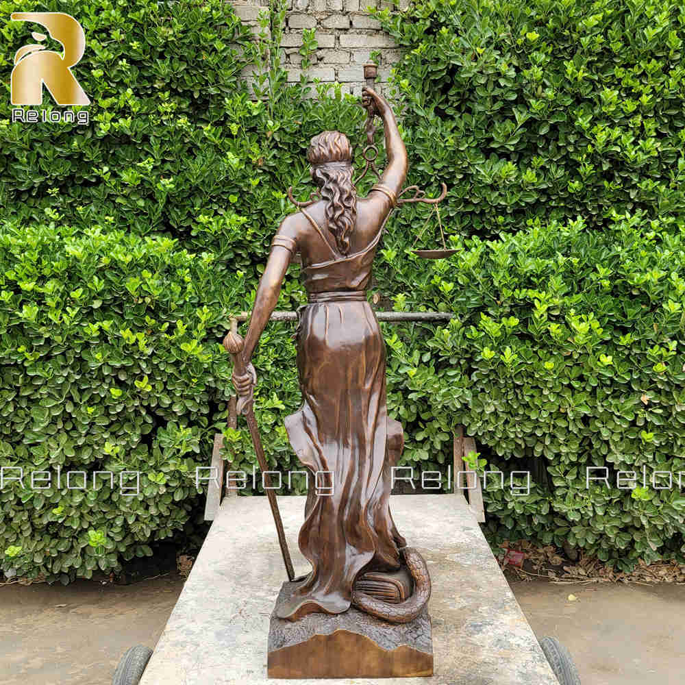 back view of bronze lady of justice statue