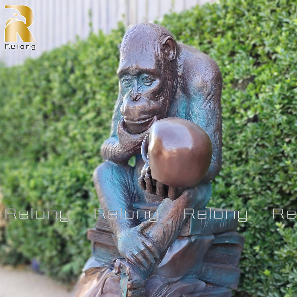 fine cast details of monkey holding skull statue