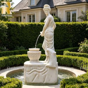 Woman pouring water statue displayed in elegant garden
