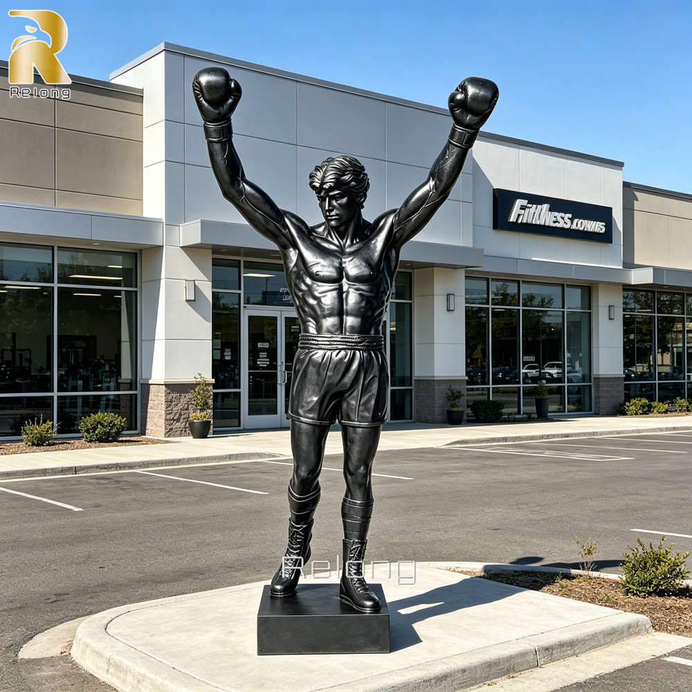 A large bronze boxer statue standing at the entrance of a modern boxing club.