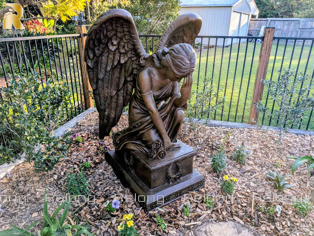 Bronze kneeling angel statue installed in an Australian garden (1)