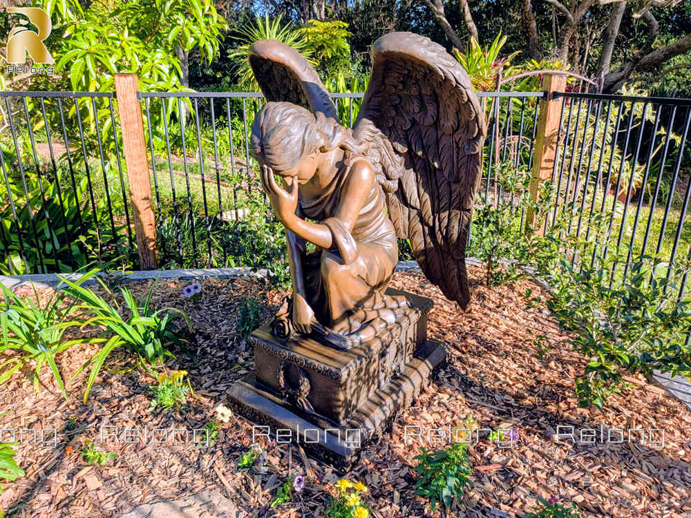 Bronze kneeling angel statue installed in an Australian garden (2)