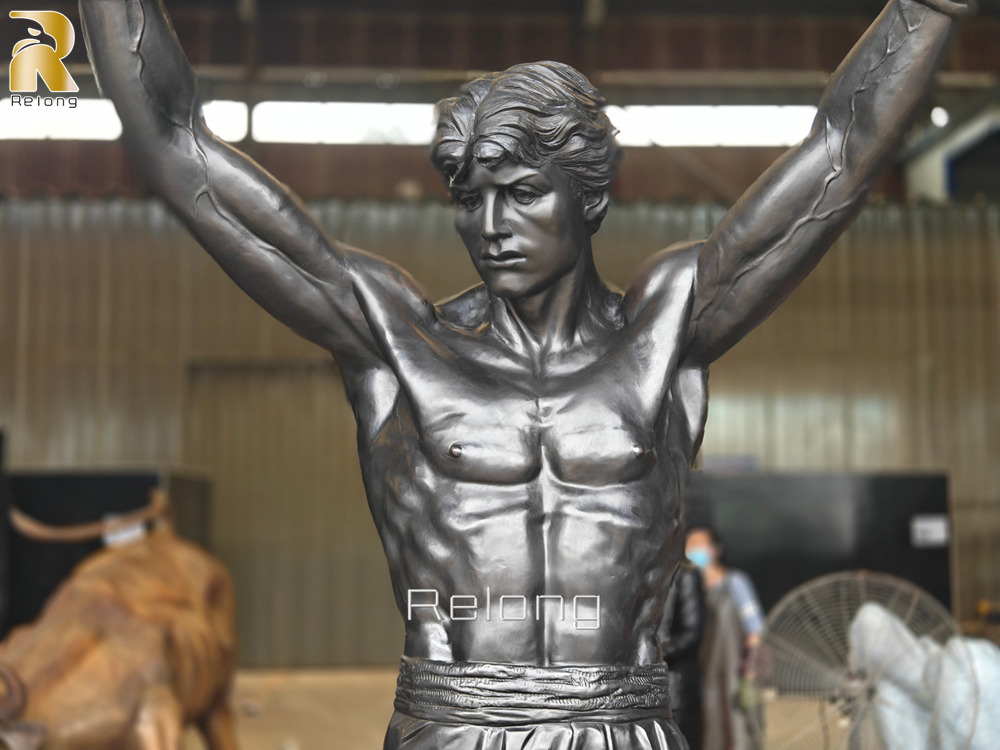Close-up of the realistic muscle definition on a bronze boxer statue
