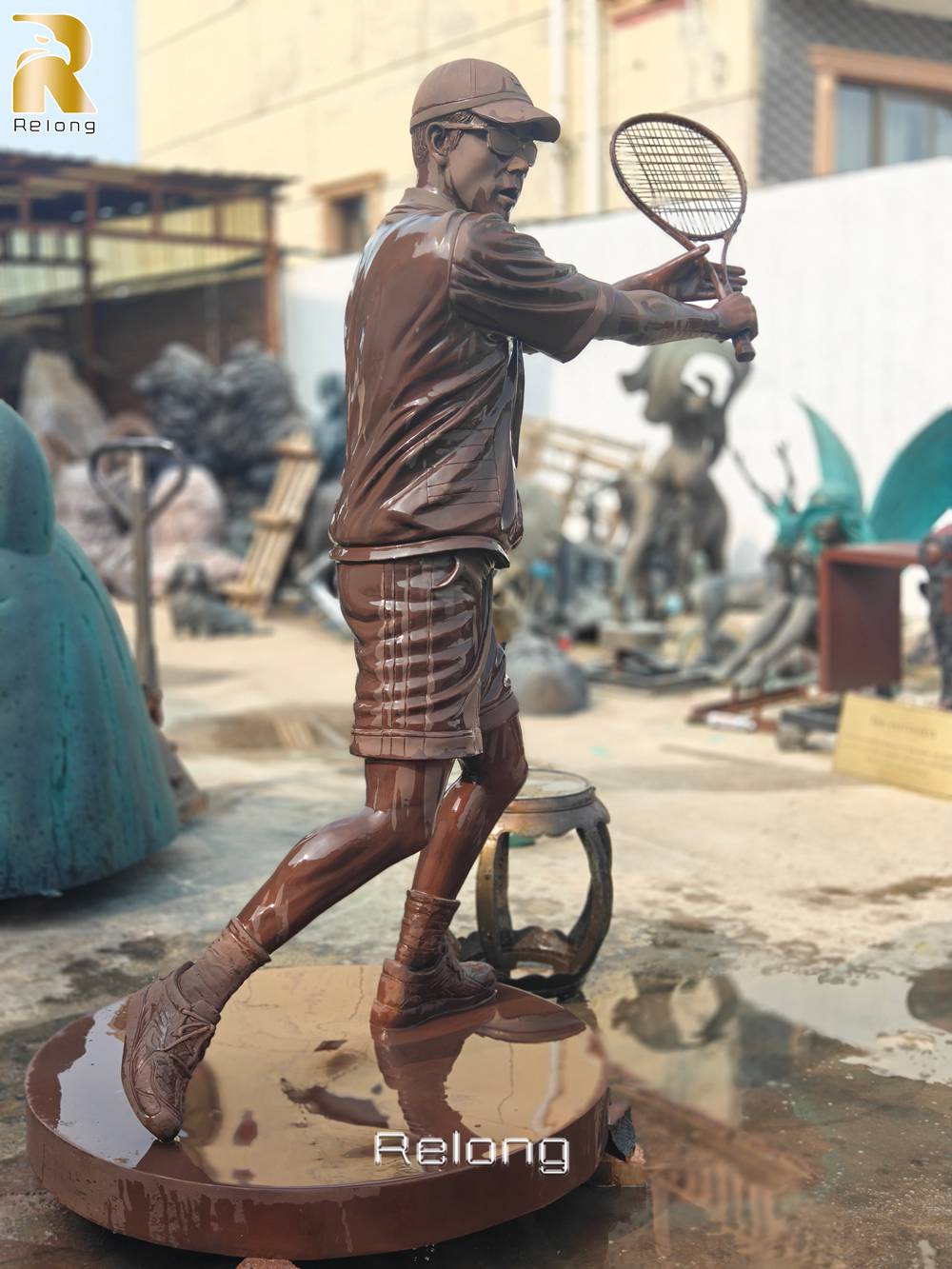 bronze tennis player sculpture side view action