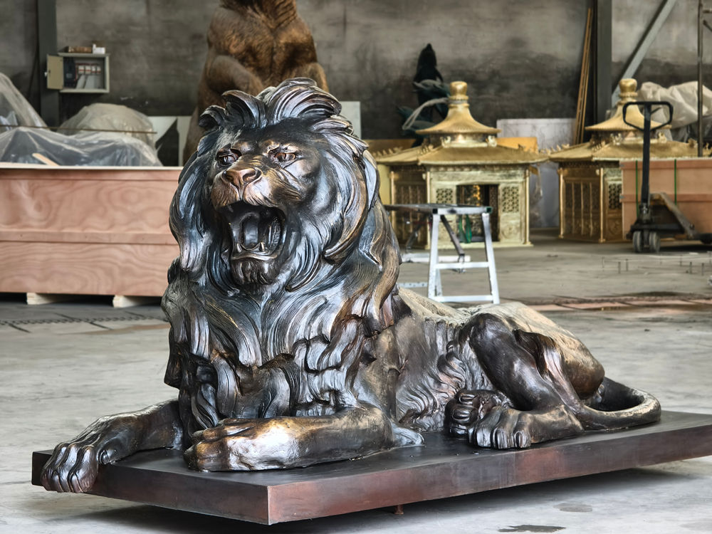 large bronze lying lion statue