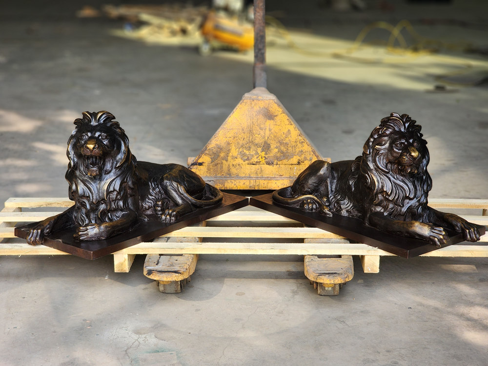 small bronze lying lion statue