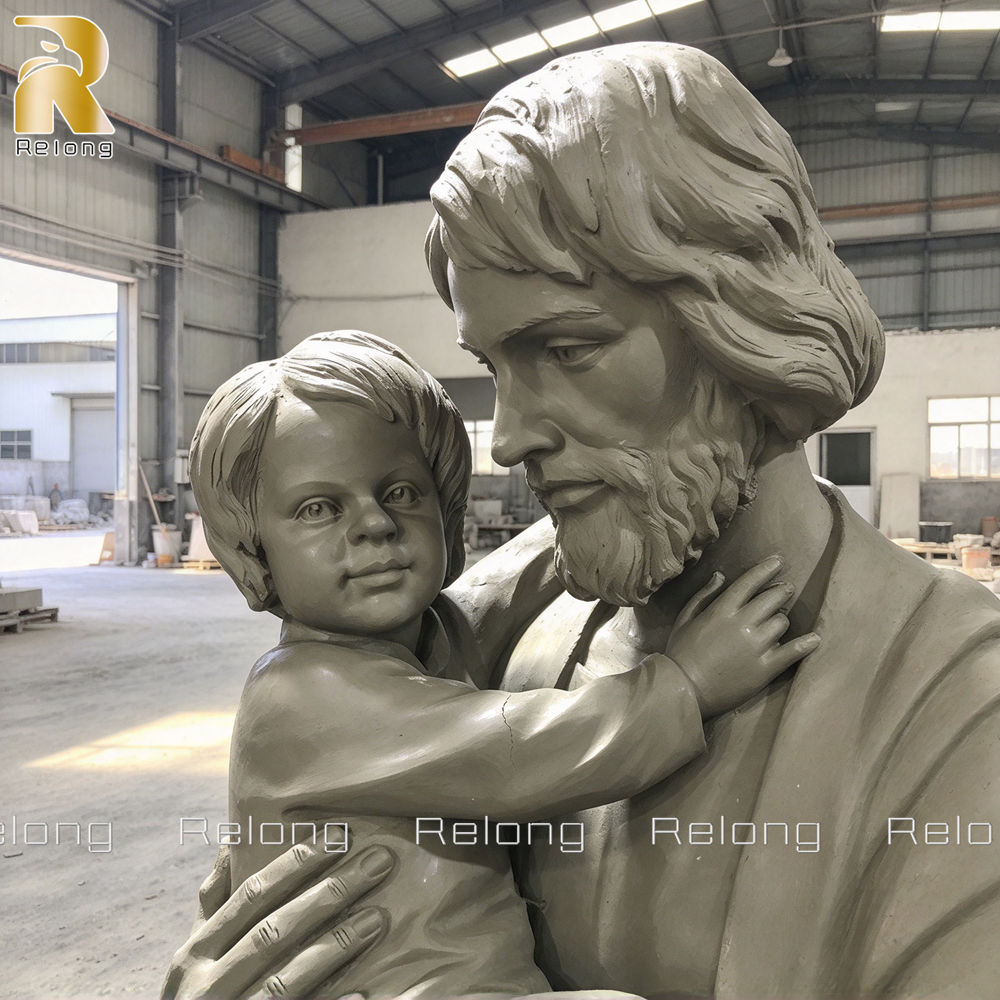 close up facial details of st joseph and baby jesus clay model